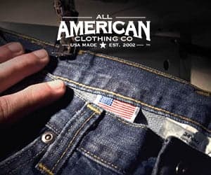 Close-up of a denim jeans pocket with an American flag tag, with the All American Clothing Co. logo overlay, from official promotional imagery.